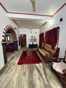 a living room with a couch and a red rug at Dragster Heritage Villa in Māla