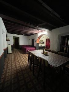 a living room with a table and a bed at Dragster Heritage Villa in Māla