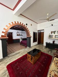 a living room with a couch and a table at Dragster Heritage Villa in Māla