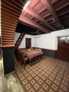 a dining room with a table and a staircase at Dragster Heritage Villa in Māla