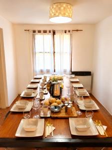 a long table with plates of food on it at Olly Patagonia Suites in San Carlos de Bariloche +11 photos