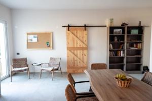 a room with a wooden door and a table and chairs at Sage Suite in Paránimfoi
