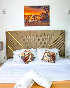 a bed with white sheets and pillows in a bedroom at The Royals in Tatu City +38 photos