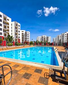 a large swimming pool with apartment buildings in the background at The Royals in Tatu City