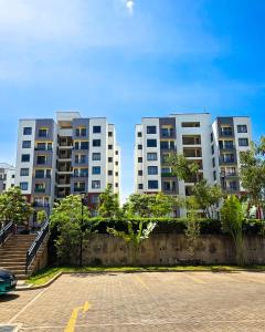 two tall apartment buildings in a parking lot at The Royals in Tatu City