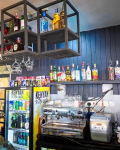 a bar with bottles of alcohol on the wall at The Royals in Tatu City