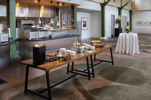 a table with food on it in front of a kitchen at Sheraton Grand Sacramento in Sacramento