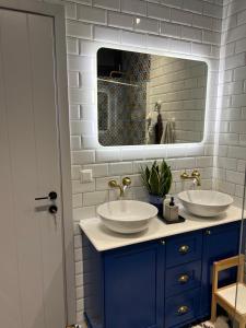 a bathroom with two sinks and a mirror at Villa ATLAS relax in Prinos +15 photos