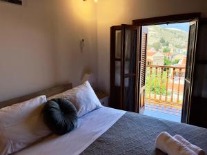 a bedroom with a bed with a view of a balcony at Twin vista getaway in Meyisti