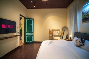 a bedroom with a bed and a green door at DoDo Apartments in Hanoi
