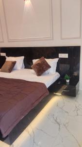 a bedroom with a large bed with pillows on it at Craviq Hotels -1 in Ghaziabad