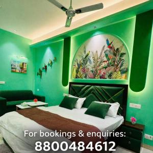 a bedroom with a bed with a painting on the wall at Craviq Hotels -1 in Ghaziabad