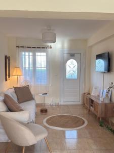 a living room with a couch and a table at Plagia Oasis Escape in Nea Plagia