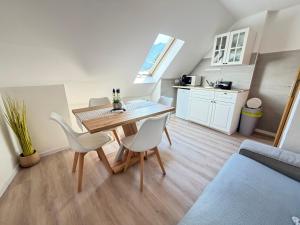 a kitchen and dining room with a table and chairs at Apartments in Green House in Bovec