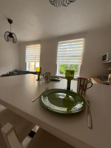 a table with a green plate on top of it at Parka ielas apartamenti in Limbaži +15 photos