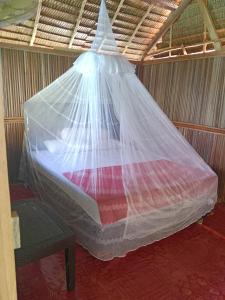 a bed wrapped in plastic in a room at Lagoon Homestay in Keruo