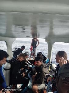 a group of people on a boat in the water at Lagoon Homestay in Keruo