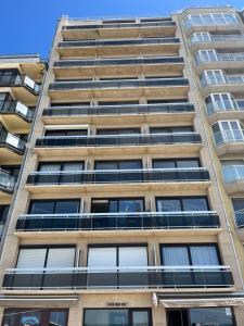 an apartment building with a lot of windows at Studio Zeester in Westende-Bad