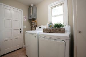 a laundry room with a washer and dryer and a window at Sweet 5 Bedroom, 4 Bath Pool Home 1/2 Mile Walk To Disney in Anaheim