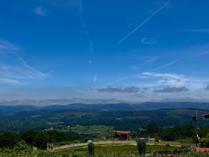 a person flying a kite on top of a hill at A Casa do Ferreiro in Cerdedo