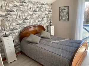a bedroom with a bed and a wall mural at Agréable Maison basque-Anglet in Anglet