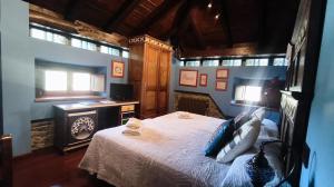 a bedroom with a bed in a room with a fireplace at Casona El Gurugu in Luarca