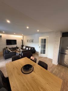 a large living room with a table and a couch at Villa Vukas in Mostar