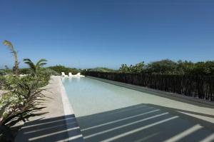 a swimming pool with a fence around it at Oceanfront Condo with Pool and Views Telchac | Depto B52 in Xtampú