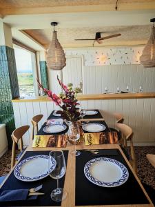 a dining room with a table with plates and glasses at Hostal Restaurante Parajes in Castropol