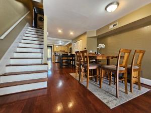 a staircase leading up to a dining room and a dining table at Two Story Queen Primary in Towson