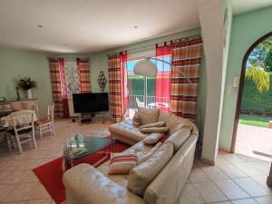 a living room with a couch and a table at Villa du Capelan - BANDOL in Bandol