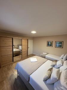 a large bedroom with two beds and a mirror at Villa Vukas in Mostar +30 photos