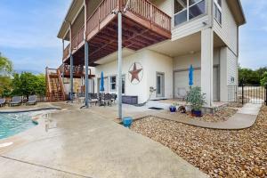 a building with a swimming pool and a house at Scenic Riverfront Home with Boat Access, Private Pool/Hot Tub - Close to Shopping in Lago Vista