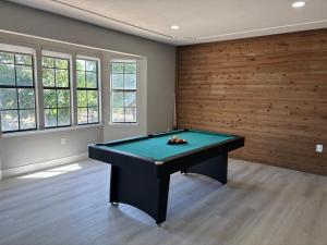 a pool table in a room with wooden walls at Vintage Vineyard Estate in Oakley