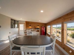 a dining room with a table and white chairs at Vintage Vineyard Estate in Oakley