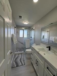 a white bathroom with a toilet and a sink at Vintage Vineyard Estate in Oakley +24 photos