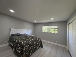 a bedroom with a bed and a window at Vintage Vineyard Estate in Oakley