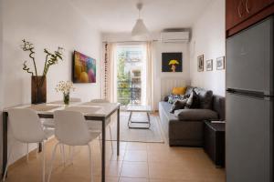 a kitchen and living room with a table and a couch at Spartan Gem Apartment in Sparta