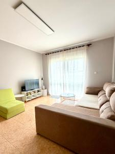 a living room with a large bed and a television at DaKing in Vila do Conde