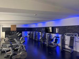 a gym with a row of treadmills and machines at Schloss Hohenkammer in Hohenkammer