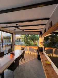 a dining room with a table and a large window at Villa Vukas in Mostar