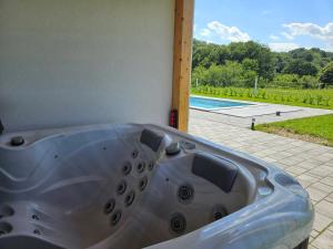 a silver bath tub with a view of a pool at Villa Hojnik in Videm pri Ptuju
