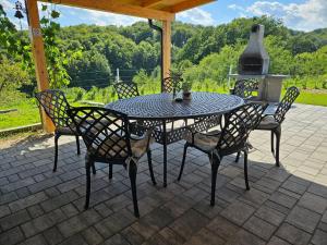 a table and chairs on a patio with a fireplace at Villa Hojnik in Videm pri Ptuju +46 photos