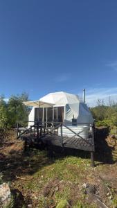 a camper is sitting on top of a hill at Refugio Volcán Hornopiren in Hornopiren