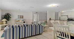 a living room with chairs and a table and a kitchen at Nature Lovers Paradise in Inverness