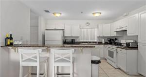 a white kitchen with white appliances and white cabinets at Nature Lovers Paradise in Inverness +10 photos