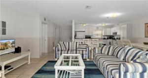 a living room with striped couches and a kitchen at Nature Lovers Paradise in Inverness