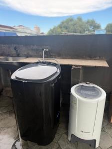 a couple of trash cans sitting next to each other at Quarto no centro 207 in Manaus +4 photos