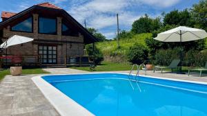a house with a swimming pool in front of a building at Kuća za odmor Zagorka in Zabok