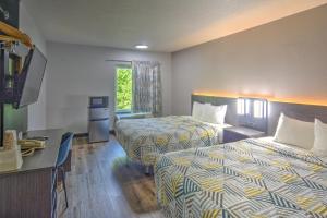 a hotel room with two beds and a desk at Motel 6-Libertyville, IL in Libertyville